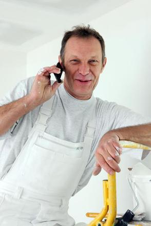 This is a picture of a painter on his phone talking to a customer.